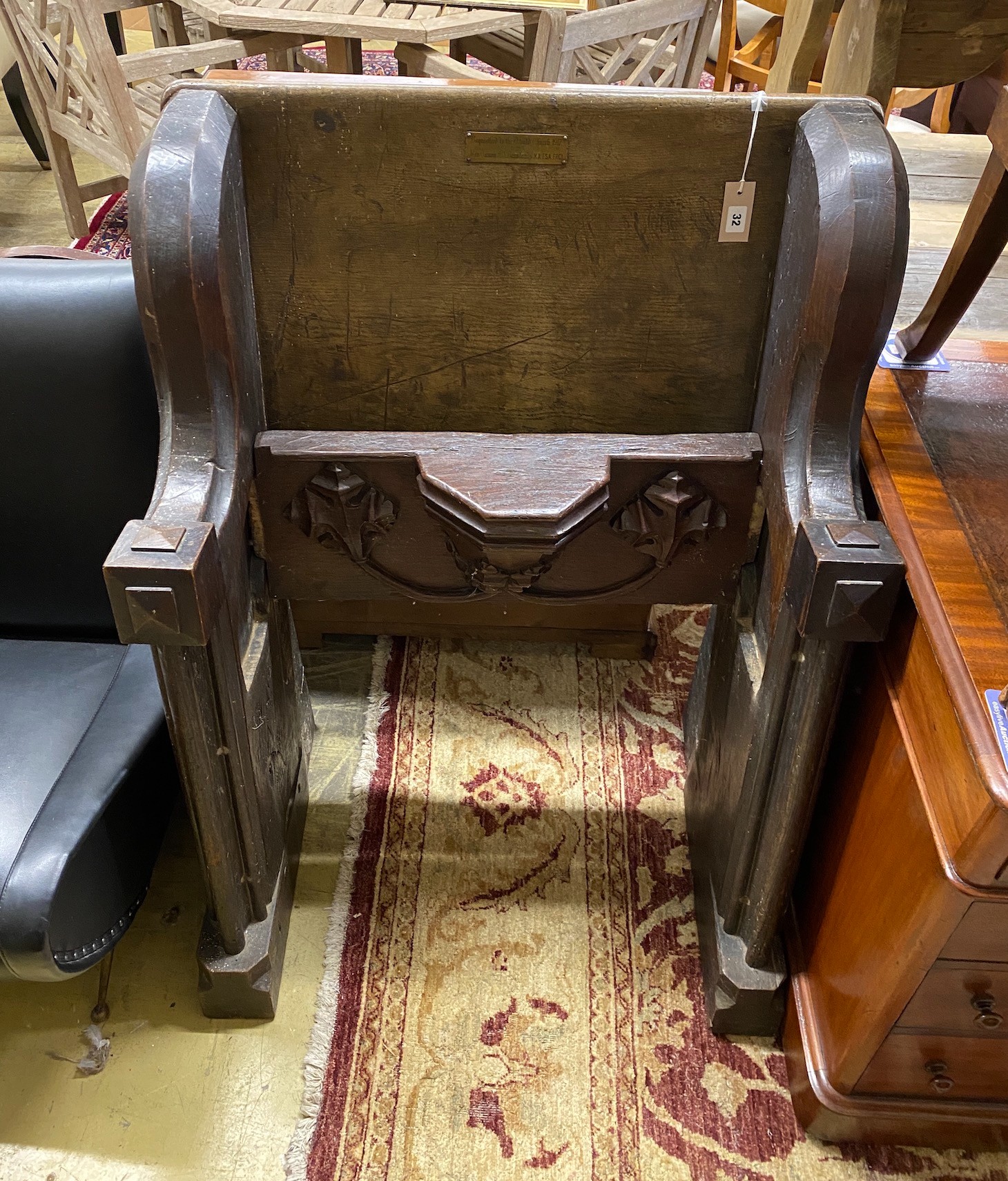 A 17th century and later oak pew with carved misericord, width 82cm, depth 40cm, height 109cm